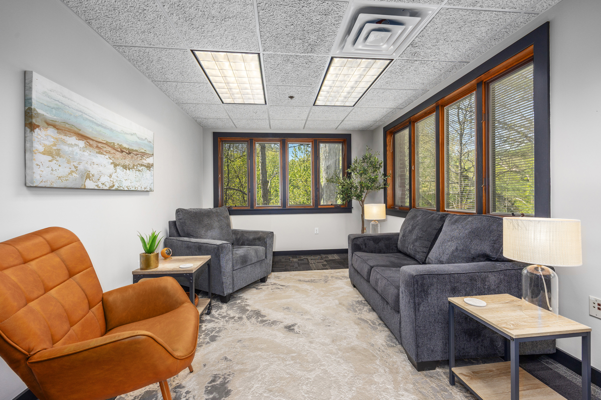 Furnished therapy office with warm lighting and comfortable seating