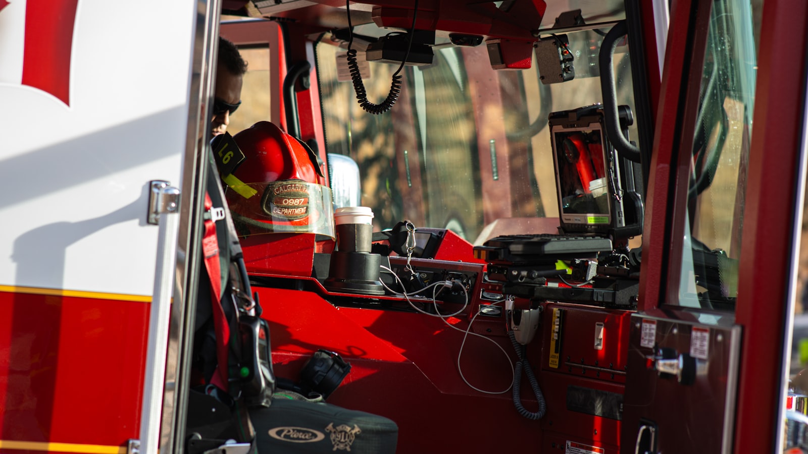 The open cab of a fire engine with gear stowed and ready